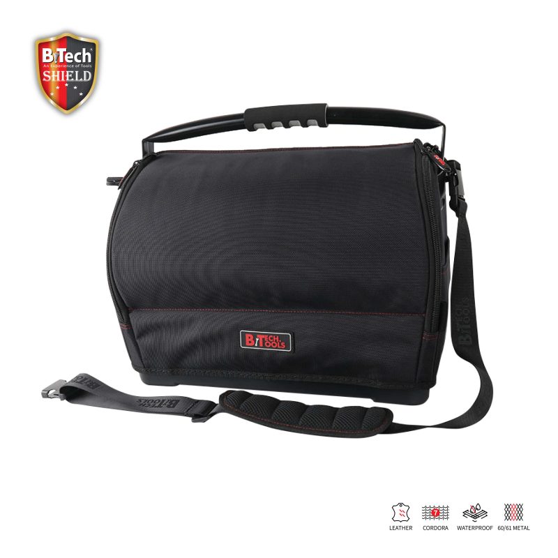 ארגונית כלי עבודה 22" SHIELD של B.Tech ידית רחבה מתקפלת דגם No.16 6M.K במבט תלת-רבעי — תיק עבודה שחור עם תפרי אדום ולוגו BiTech Tools אדום בולט, ידית אלומיניום שחורה רחבה וארגונומית בראש התיק המתקפלת ישר, רצועת כתף שחורה עם אבזם מתכתי ומגן כתף מרופד. איקונים של Leather/Cordura/Waterproof/60-61 Metal לתכונות עמידות. מק"ט 0503865 — תיק מקצועי לשיפוצניקים וחשמלאים נוסעים.
